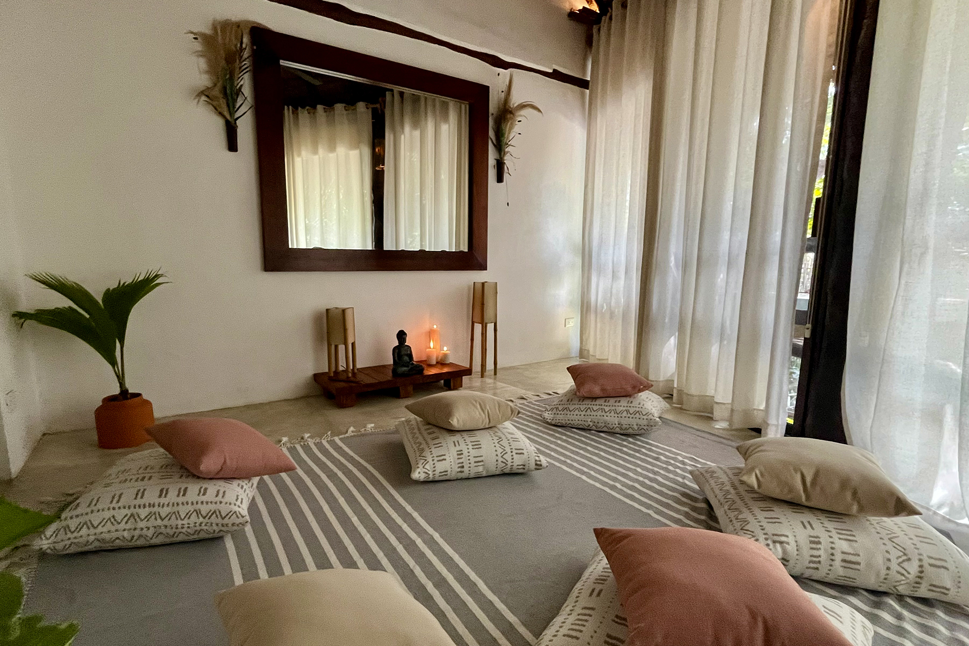 Private meditation room at The Beach Tulum hotel, with comfortable cushions, a Buddha, incense and air conditioning.