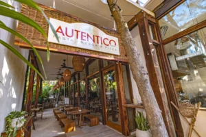 Entrance of Autentico with white sign, name and logo