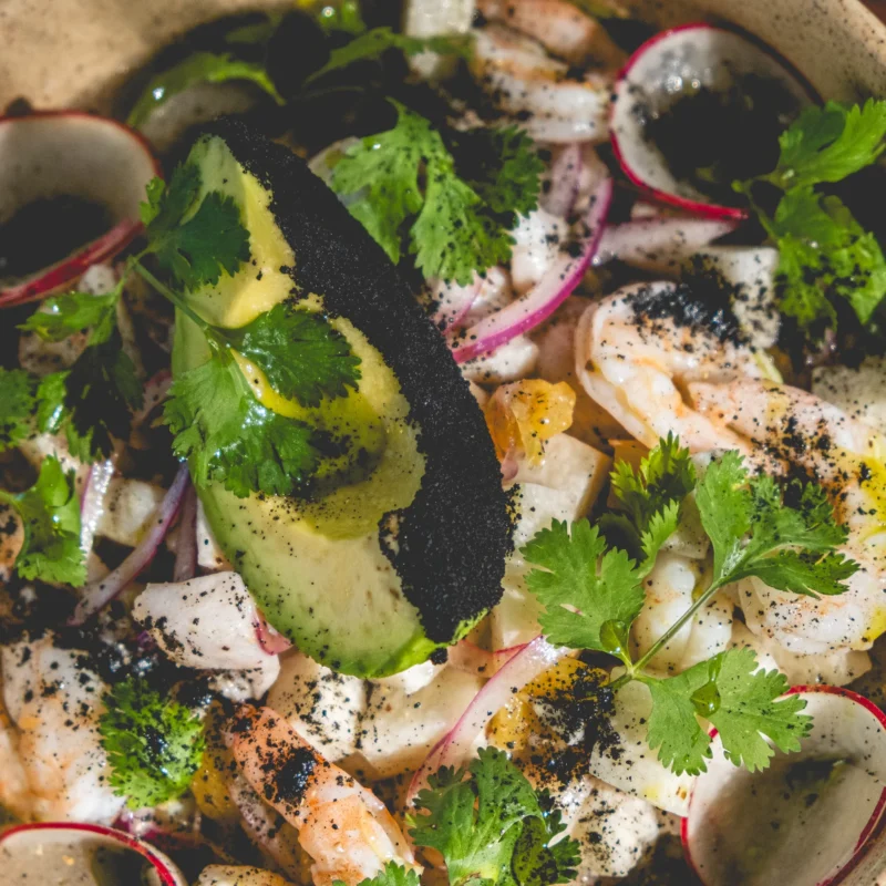 yucatan ceviche Yucatan ceviche with Shrimp, fresh fish + nixtamalized pineapple + jicama + sour orange + red onion + coriander seeds + habanero oil and Recado Negro.